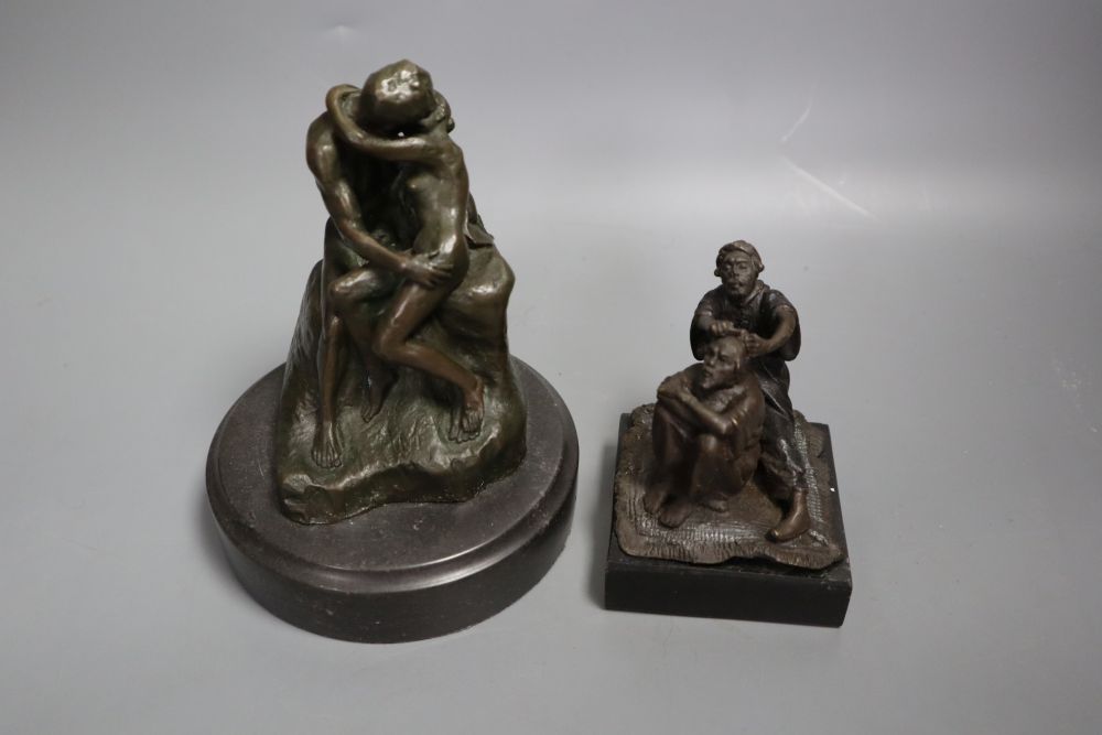 A cast metal sculpture Kiss after Rodin, height 14cm and another of Arabs